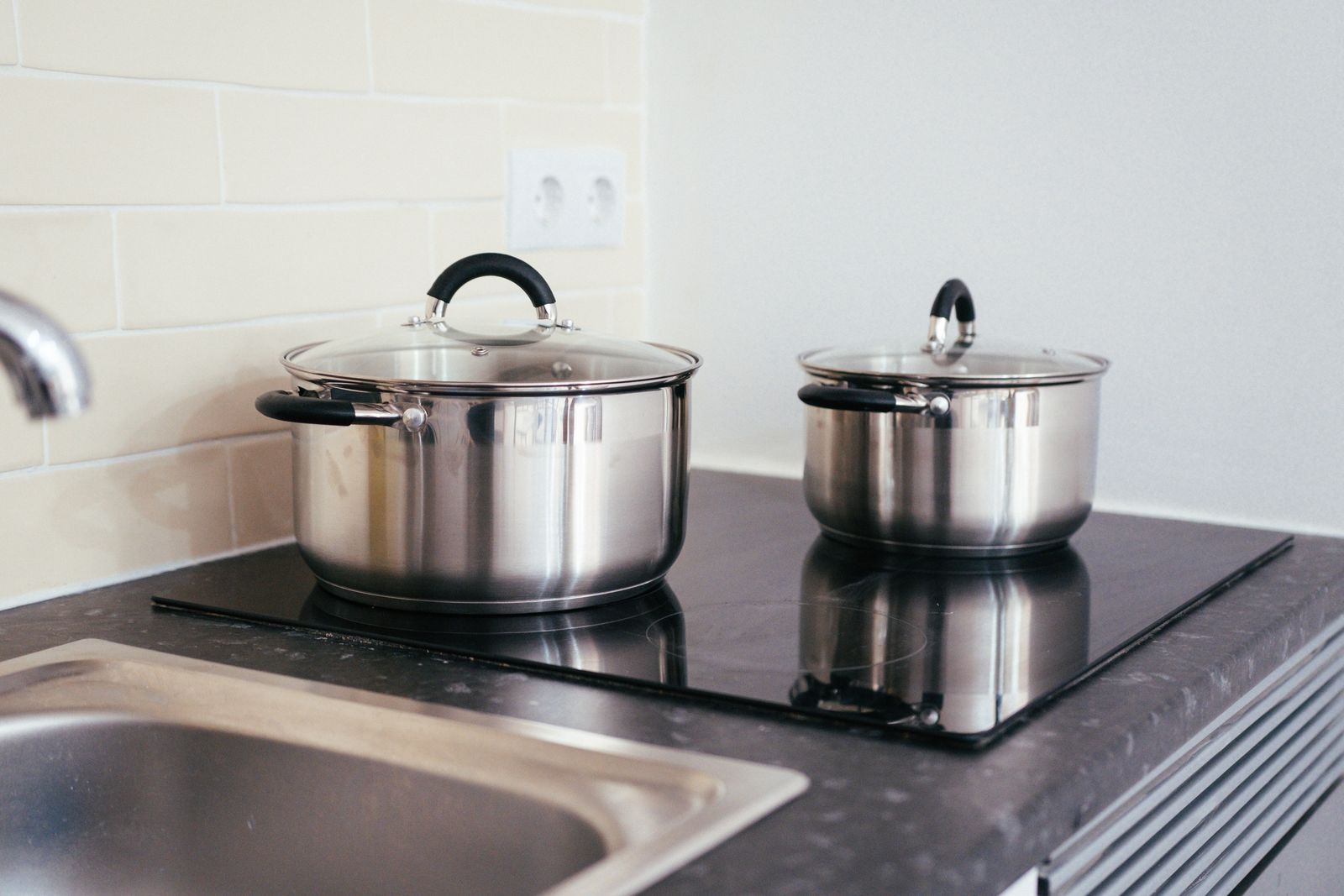 An induction cooktop set into a stone countertop — professional Miele cooktop repair