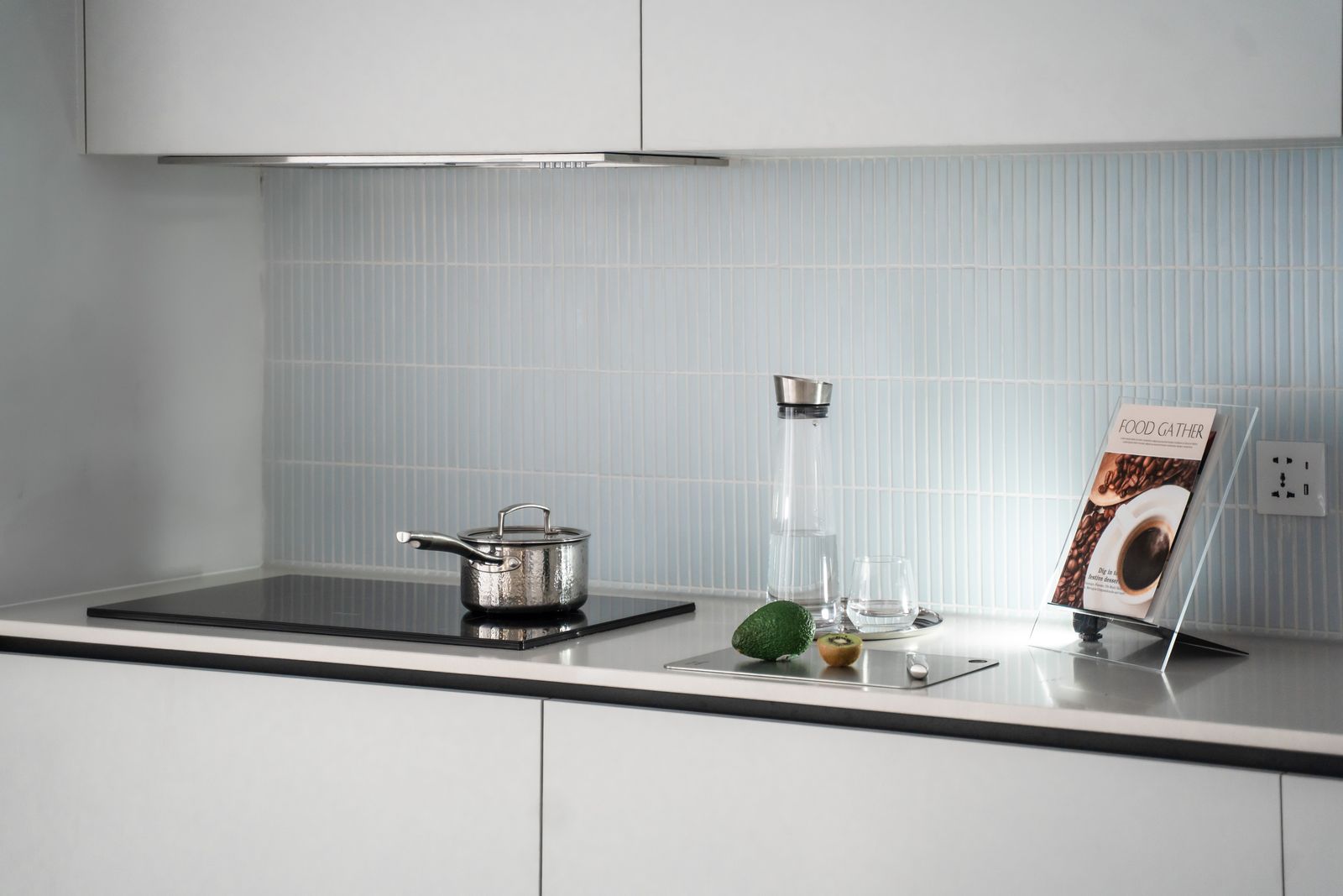 A black glass induction cooktop in a modern kitchen — professional Miele cooktop repair