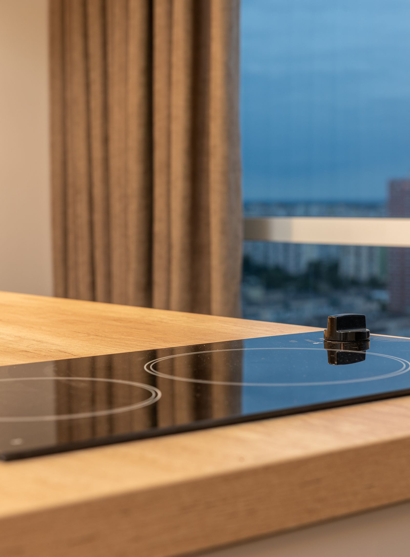 An induction cooktop set into a stone countertop — professional Miele cooktop repair