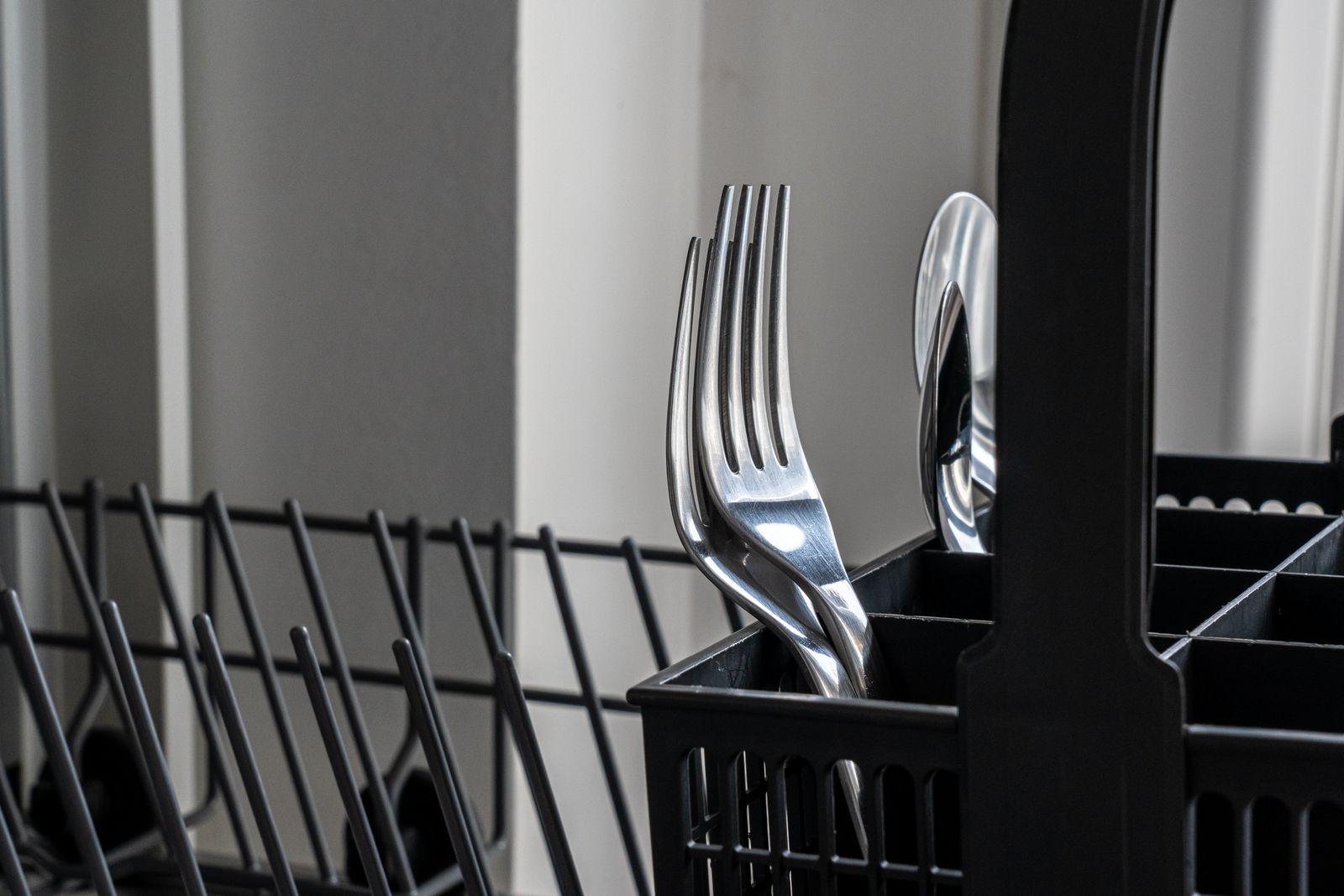 The cutlery tray and upper rack of a built-in dishwasher — professional Miele dishwasher repair