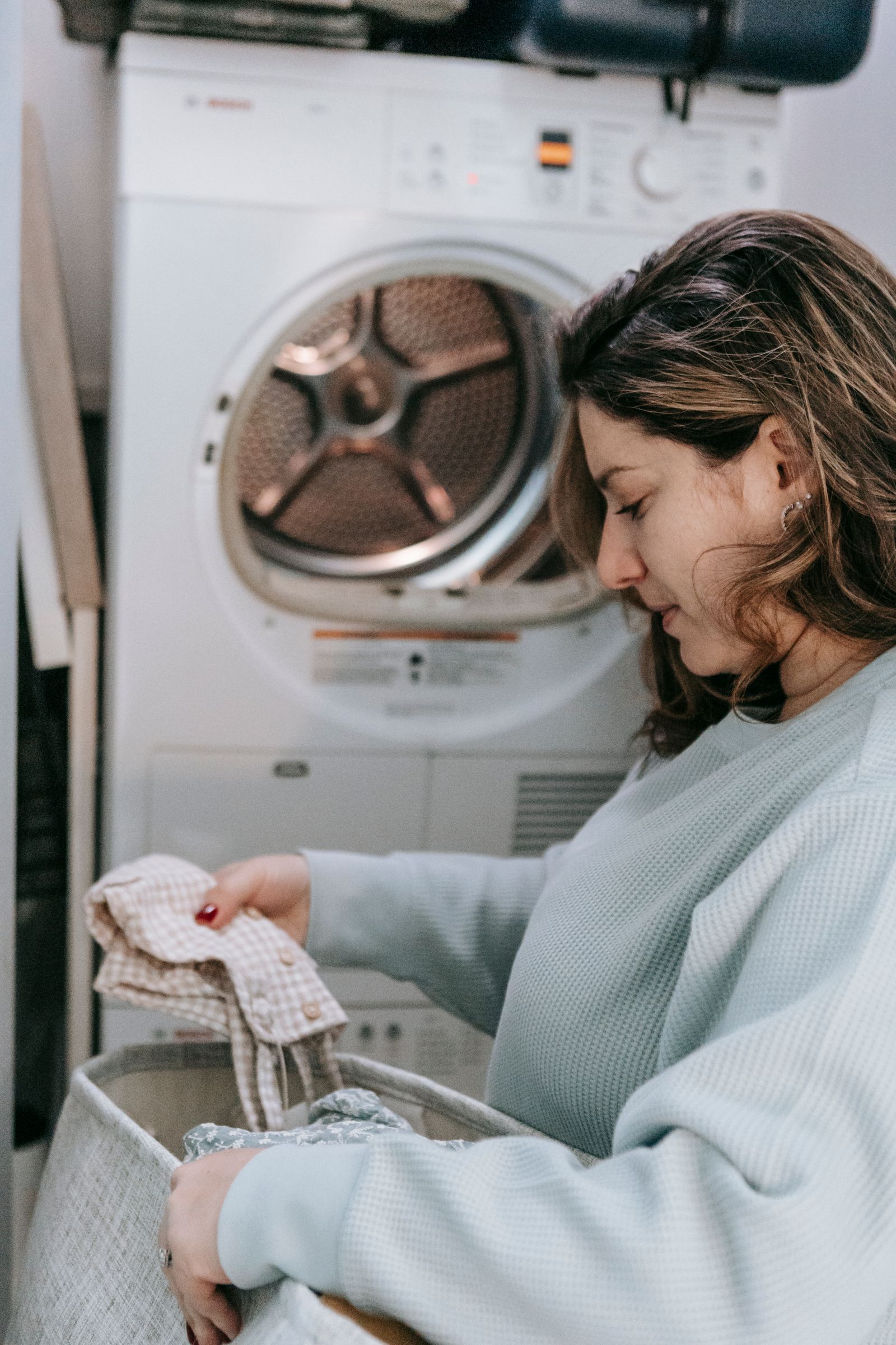 A front-load clothes dryer in a home laundry room — professional Miele dryer repair