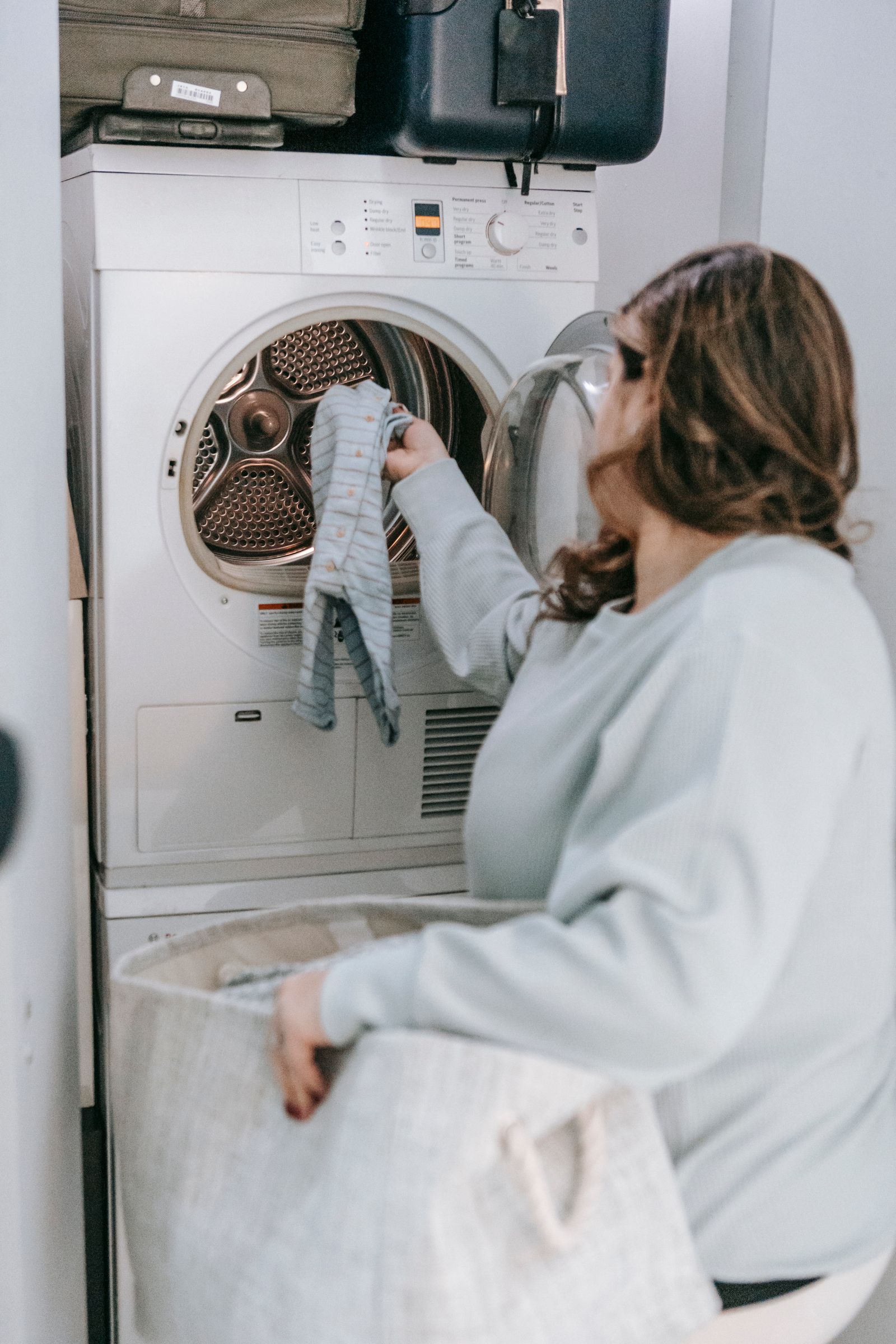 Loading laundry into a front-load dryer — professional Miele dryer repair