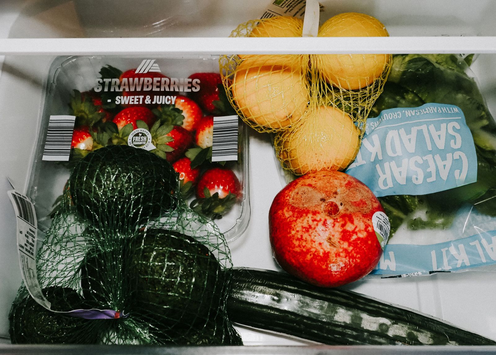 An open refrigerator stocked with fresh produce — professional Miele refrigerator repair