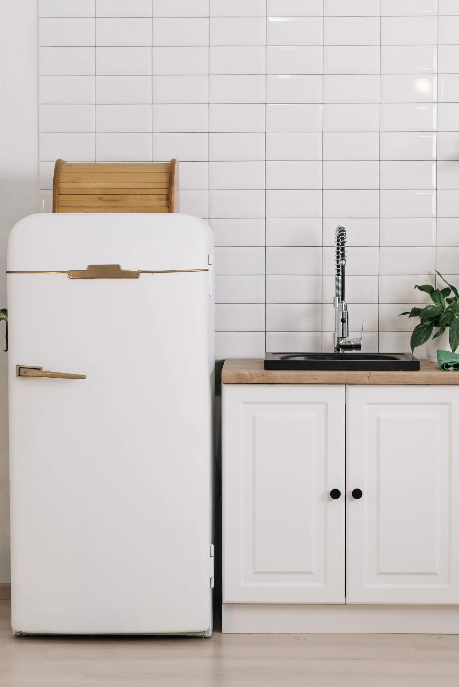 A bottom-freezer refrigerator in a bright kitchen — professional Miele refrigerator repair