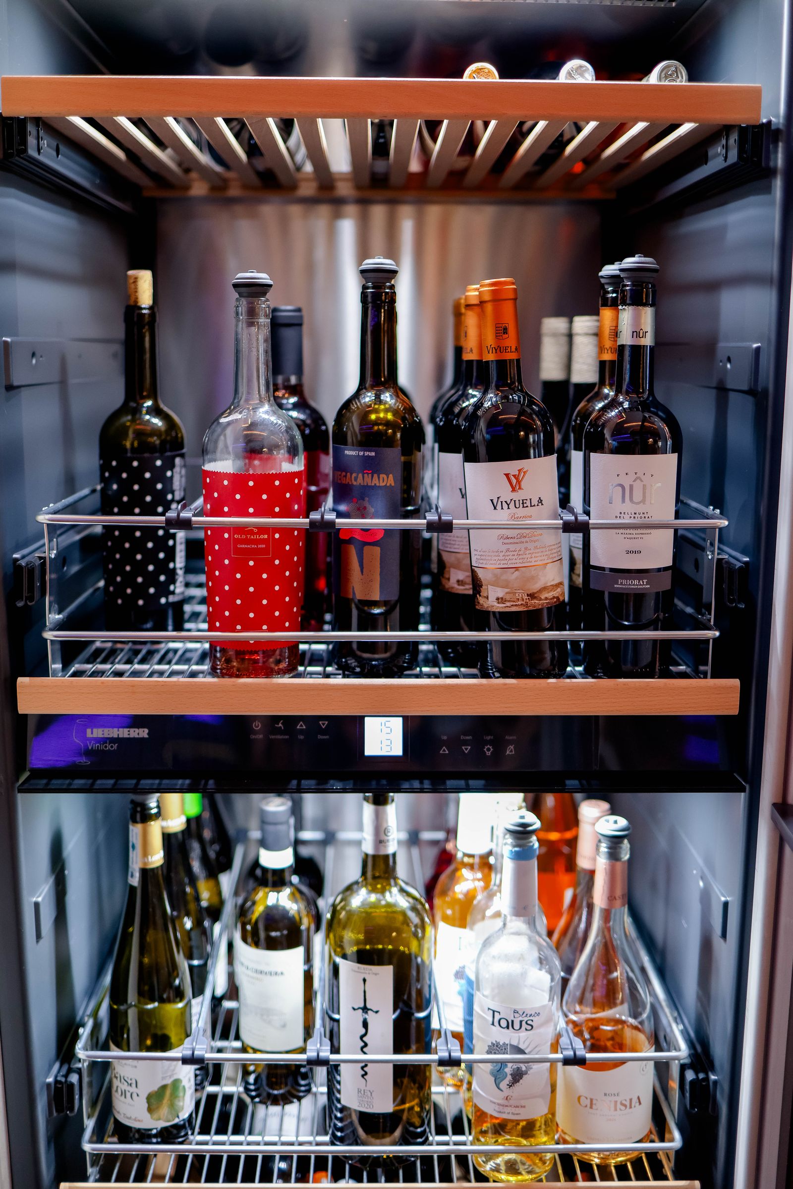 Wine bottles stored in a temperature-controlled wine cabinet — professional Miele wine cooler repair
