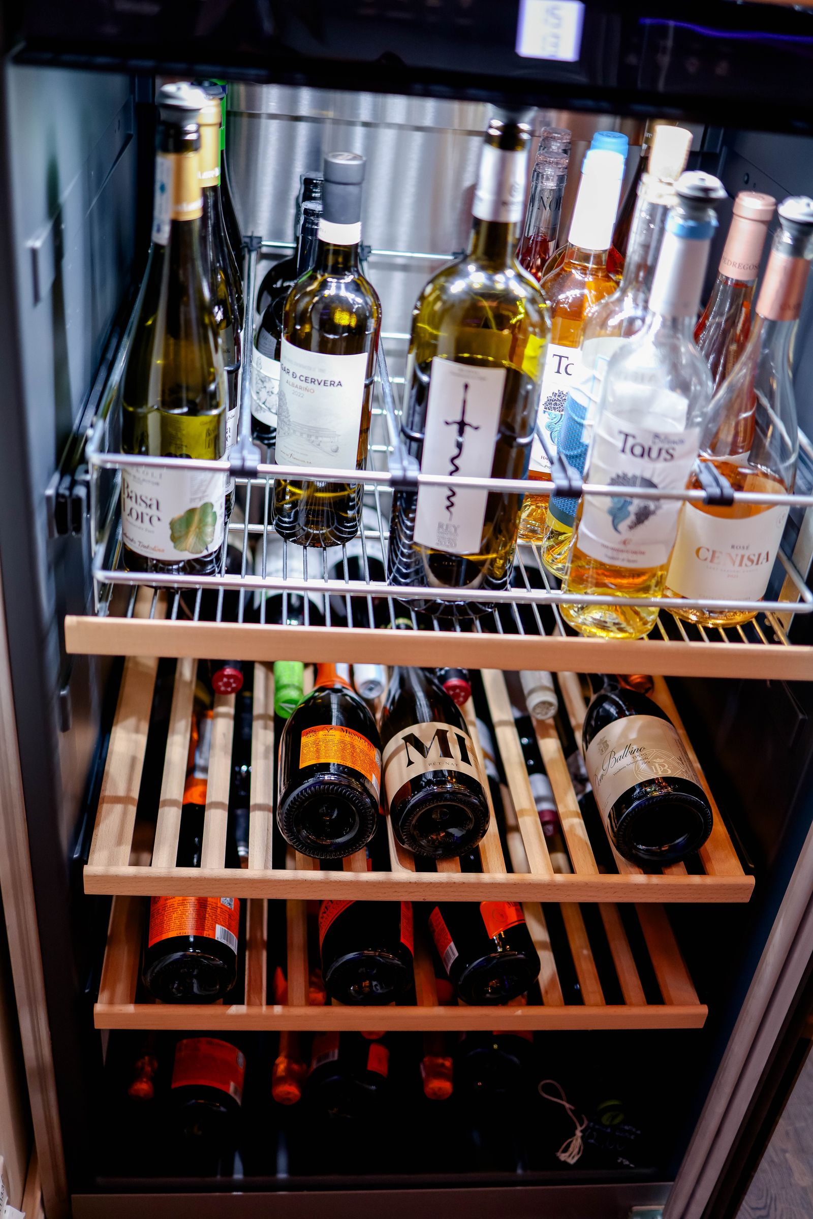 The shelves of a dual-zone wine refrigerator — professional Miele wine cooler repair